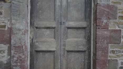 Close-up-of-a-worn-out-wooden-door-at-St-James-Church-in-Wales