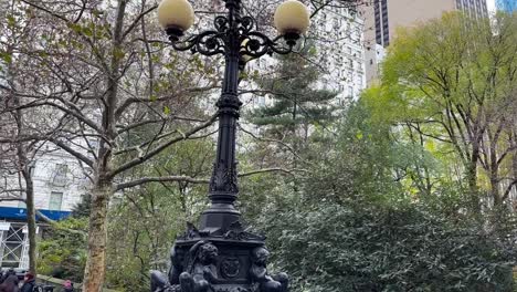 Ornate-Central-park-street-light,-looking-up-to-Plaza-hotel,-Manhattan,-New-York-city