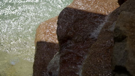 Running-water-into-over-rock-into-outdoor-pool-rock-fountain
Close-up