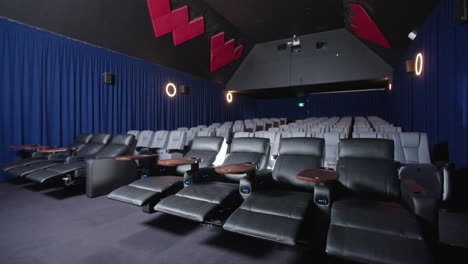 Luxury-Leather-Recliner-Seating-In-Movie-Cinema-With-Projector-Casting-Light-Flare,-4K