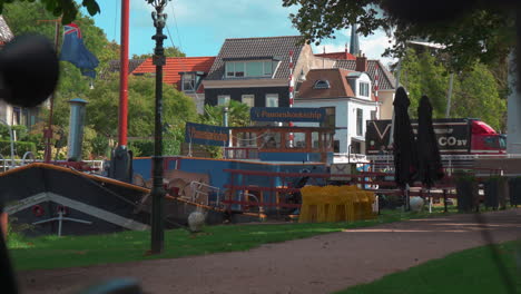 Pancake-restaurant-on-a-ship-floating-on-a-small-dutch-canal,-on-a-beautiful-summer-day