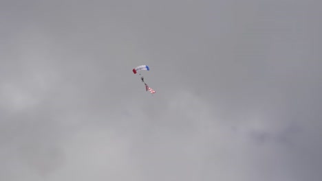 The-American-Flag-arrives-by-sky-diver-as-the-Texas-Flag-crosses-the-path-to-land-at-the-Wings-over-Houston-Airshow-2021