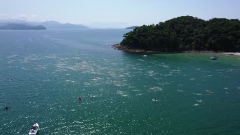 Aerial-view-of-a-swim-meet,-on-the-coast-of-sunny,-Saint-Sebastian,-Brazil