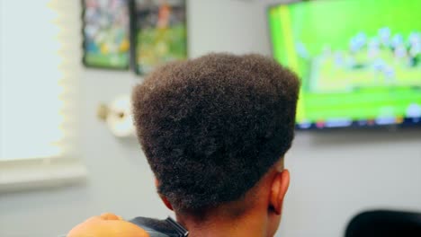 Barber-using-trimmer-on-black-boy-hair