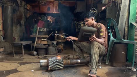 Welder-welding-metal-machine,-worker-doing-metalwork-at-workshop-factory-in-Bangladesh