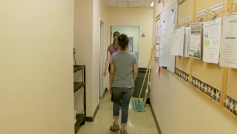 Two-women-walking-down-a-hallway-in-an-elementary-school