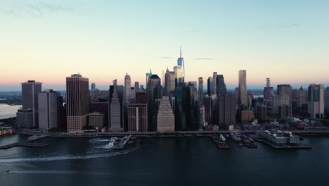 East-river,-Brooklyn-bridge-and-the-skyline-of-lower-Manhattan,-dawn-in-New-York,-USA---Aerial-view