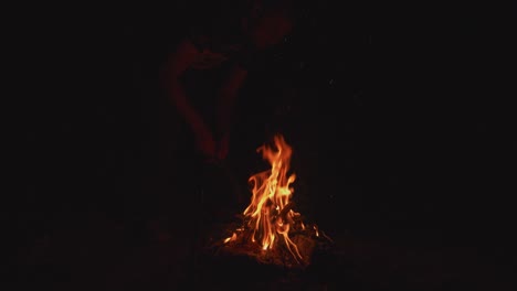 The-embers-of-a-campfire-glow-in-the-darkness-of-the-wilderness