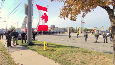 Huge-Canadian-flag-raised-above-street-in-Toronto-for-police-officer-memorial