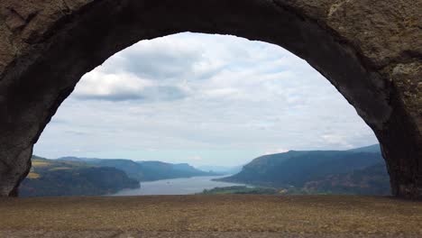 4K-Nice-static-view-of-the-Columbia-River-through-an-archway-with-mostly-cloudy-sky