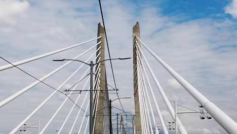 HD-Looking-up-going-across-Tilikum-Crossing-Bridge-in-Portland-Oregon-with-mostly-cloudy-sky-take-one