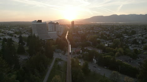 Public-Transportation-Sky-train-Heading-Towards-the-Sunset-in-Downtown-Vancouver-Aerial