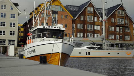 Luxury-boats-and-ships-moored-to-dock-in-Tromso-harbour-in-Norway