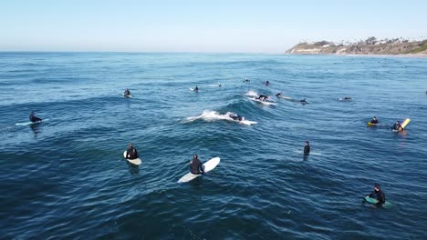surfers-lined-up-in-the-water,-Encinitas