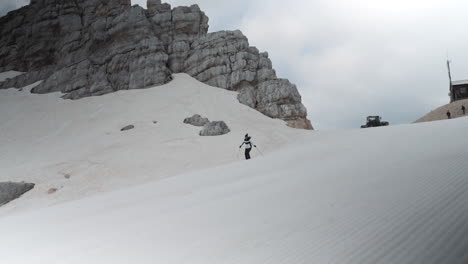 Woman-skiis-downhill-on-mountain-Kanin-on-white-snowy-slopes