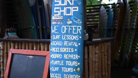 surfboard-sign-on-the-beach,-surfboard-rental,-surfboards-for-rent