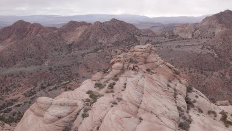 Yant-Flats-Orbit-with-St-George,-Utah-in-the-distance