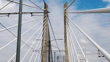 HD-Looking-up-going-across-Tilikum-Crossing-Bridge-in-Portland-Oregon-showing-part-of-the-name-on-the-bridge-near-end-of-clip-with-mostly-cloudy-sky-take-two