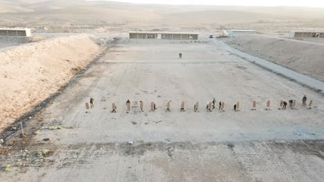 Drone-shot-Rows-of-First-Army-soldiers-practicing-target-shooting-in-the-desert
