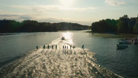 Aerial,-group-of-people-water-skiing-as-a-group-on-lake-at-a-water-ski-show-during-summer