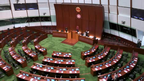 Bird's-eye-view-of-an-empty-Legislative-Council-main-chamber-as-the-People's-Republic-of-China-and-Hong-Kong-Special-Administrative-Region-emblems-seen-above-the-presidential-elected-chair