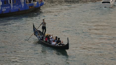 Gondolier-Drives-Gondola-With-Tourists-In-Venice