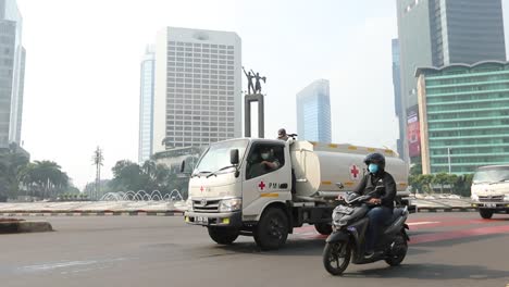 a-disinfectant-spray-car-to-eliminate-the-covid-19-virus-crosses-the-heart-of-the-capital-city-of-Jakarta-to-be-precise-at-the-Monas-horse-statue-monument