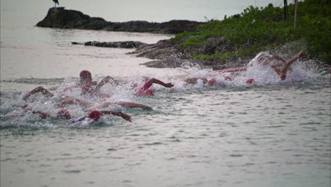 Group-of-latin-teenage-boys-contestants-participants-competitors-starting-a-triathlon-competition-from-inside-the-water