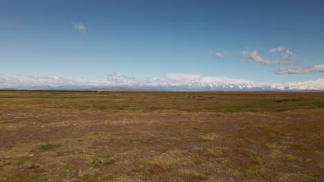 Expansive,-dry-prairie-plains-with-picturesque-mountain-range-in-distance