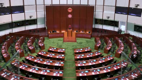 Bird's-eye-view-of-an-empty-Legislative-Council-main-chamber-as-the-People's-Republic-of-China-and-Hong-Kong-Special-Administrative-Region-emblems-seen-above-the-presidential-elected-chair