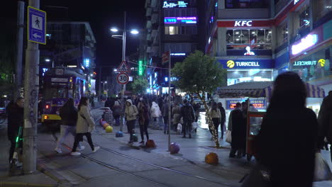 Tram-with-Getir-Commercial-Driving-on-Busy-Street-in-Istanbul-at-Night