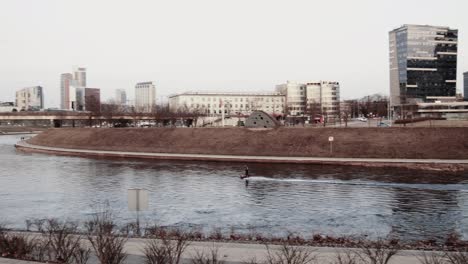 A-Man-on-an-Electric-Water-Board-on-the-Neris-River-in-Vilnius,-Lithuania