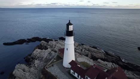 Aerial-parallax-of-Portland-Head-Lighthouse,-winter-time-in-Maine-on-Cape-Elizabeth-coast