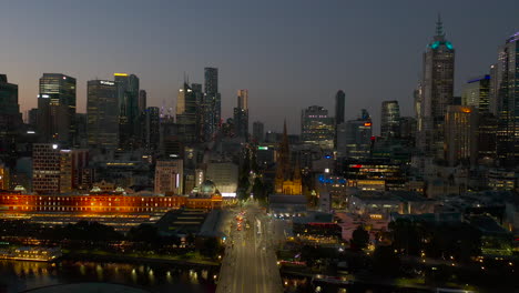 Aerial-reveal-of-Melbourne-CBD-against-brilliant-gradient-dusk-sky