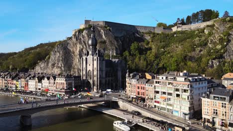 Aerial-view-of-Notre-Dame-in-Dinant-Waloon-Belgium-tracking,-wide-shot