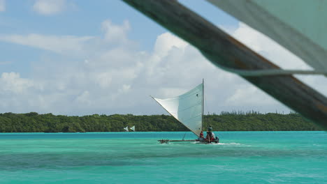 Traditional-outrigger-pirogue,-or-canoe,-touring-famous-Upi-Bay,-Isle-of-Pines