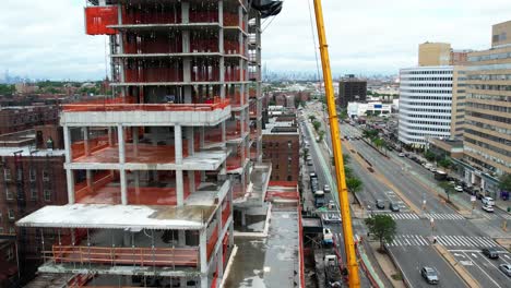 Aerial-view-around-a-construction-crane-at-a-project-site-in-New-York,-USA---circling,-drone-shot