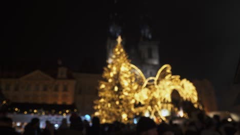 Christmas-markets-in-Prague-city,-tree-lights-and-crowds-of-people,-soft-focus-view