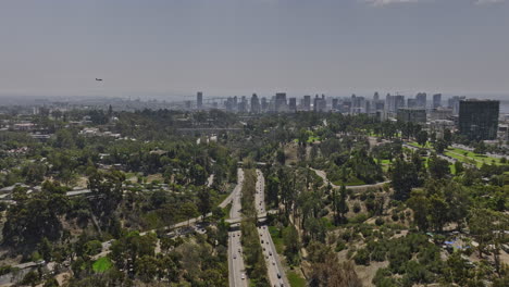 San-Diego-California-Aerial-v75-flyover-balboa-park-above-cabrillo-freeway-capturing-bridge-and-downtown-cityscape-with-airplane-flying-across-the-sky---Shot-with-Mavic-3-Cine---September-2022