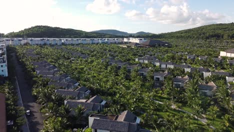Drone-flyover-Touristic-villas-from-Hotel-resort-surrounded-by-lush-vegetation,-Phu-Quoc-Island,-Vietnam