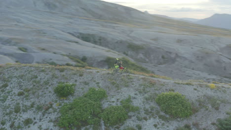 Two-mountainbikers-standing-on-mountain-trail-ridge-at-foothills-of-Mount-St