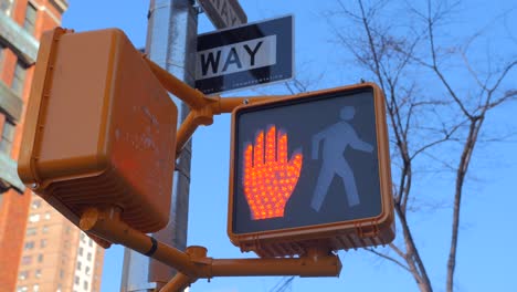 Red-Traffic-Signal-Don't-Walk,-Raised-Hand-At-The-Crossing