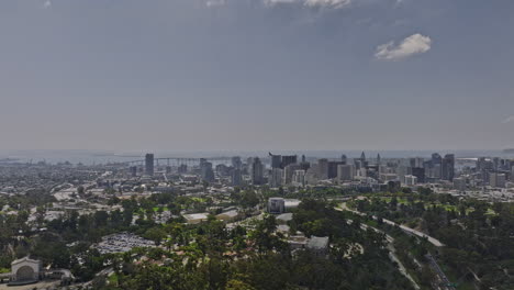 San-Diego-California-Aerial-v64-flyover-balboa-park-with-bay-views-capturing-downtown-cityscape-and-airplane-flying-across-the-sky,-landing-at-the-airport---Shot-with-Mavic-3-Cine---September-2022