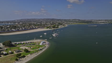 San-Diego-California-Aerial-v80-flyover-vacation-isle,-fly-along-the-shore-of-crown-point-park-and-beach-with-fiesta-mission-bay-views-at-daytime-in-summer---Shot-with-Mavic-3-Cine---September-2022
