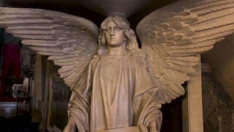 Reveal-of-life-size-marble-statue-of-an-angel-in-catholic-Candelária-church-with-a-text-written-in-Latin-on-a-banner-in-hands