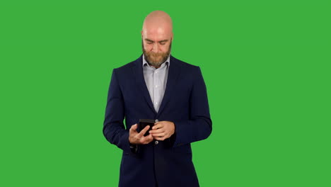 A-businessman-with-beard-taking-phone-out-of-pocket-and-using-it-to-text