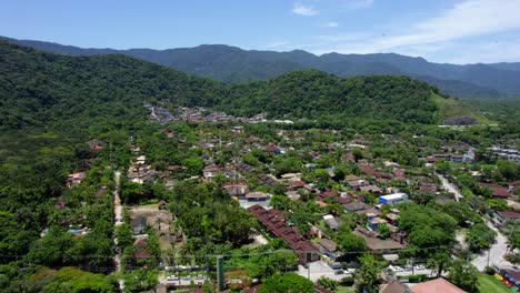 Aerial-view-flying-over-the-Barra-Do-Sahy-village,-in-sunny-Sao-sebastiao,-Brazil