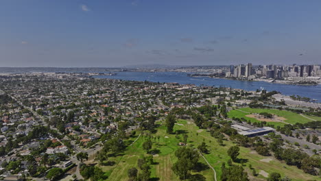 San-Diego-California-Aerial-v55-drone-flyover-public-golf-course-in-coronado-island-overlooking-at-downtown-cityscape-across-the-bay-at-daytime-in-summer---Shot-with-Mavic-3-Cine---September-2022