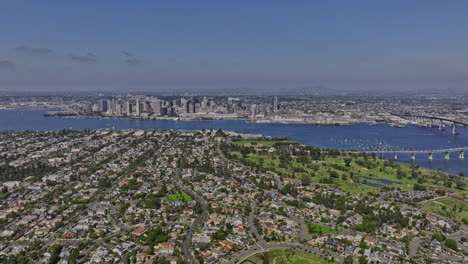 San-Diego-California-Aerial-v62-panning-view-flyover-glorietta-bay-capturing-coronado-neighborhood,-bayfront-municipal-golf-course-and-downtown-cityscape---Shot-with-Mavic-3-Cine---September-2022