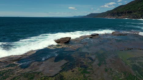 Aerial-drone-view-of-cinematic-scenic-seaside-rock-shelf-fairy-pool-in-4K-UHD